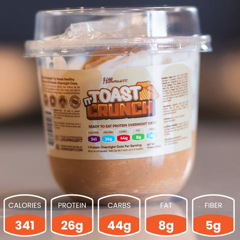 A plastic container of Hummus Fit Toast Crunch protein overnight oats sits on a table, with a nutrition label and a graphic overlay showing: 341 calories, 26g protein, 44g carbs, 8g fat, and 5g fiber per serving.