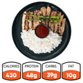The Arnold 2022 Bowl features sliced grilled chicken, asparagus, white rice, and sauce—an ideal healthy lunch with 430 calories, 48g protein, 39g carbs, and 10g fat.