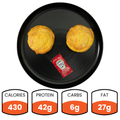 Two Bacon Cheddar Egg Muffins with a ketchup packet are served on a black plate—ideal for healthy breakfast meal prep. Nutrition: 430 calories, 42g protein, 6g carbs, and 27g fat.