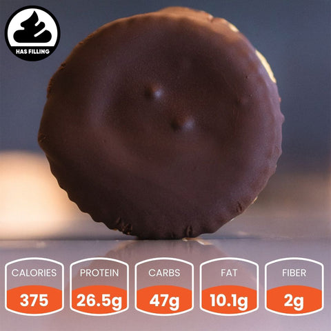 The Buffin Muffin in Boston Chocolate Creme is shown upright with a shiny surface and filling icon—perfect as a high-protein snack. Per serving: 375 calories, 26.5g protein, 47g carbs, 10.1g fat, 2g fiber.