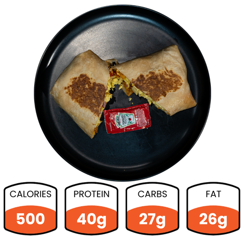 The Breakfast Burrito (Subscription) features turkey bacon, is served halved with hot sauce, and packs 500 calories, 40g protein, 27g carbs, and 26g fat—ideal for high-protein meal prep.