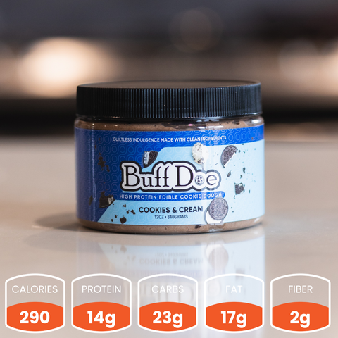 A jar of Buffdoe Cookies & Cream - Subscription sits on a counter. Each serving has 290 calories, 14g protein, 23g carbs, 17g fat, and 2g fiber.