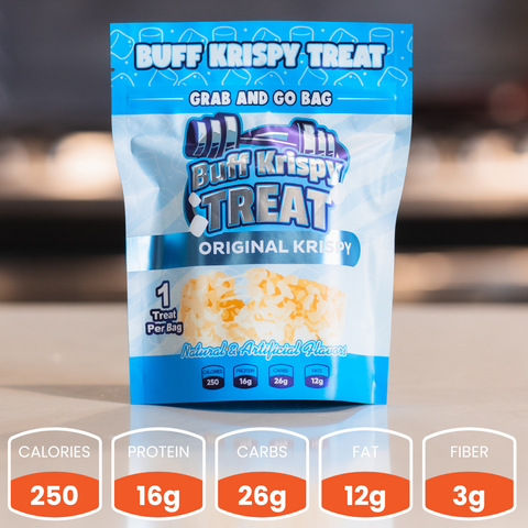A blue and white Buff Krispy Treat sits on a counter. With 250 calories, 16g protein, 26g carbs, 12g fat, and 3g fiber, this protein treat is perfect for muscle recovery and makes a tasty snack.