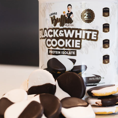 A container of Lianas Buffin Muffin - Protein Isolate stands behind black and white frosted cookies, highlighting its dessert-inspired flavors with visible nutritional details on the packaging.