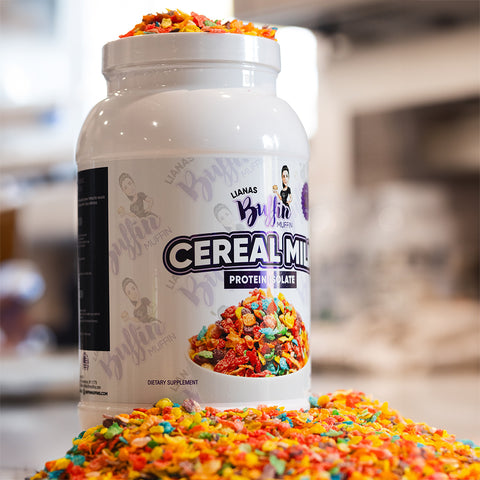 A large white container labeled Lianas Buffin Muffin - Protein Isolate sits amid vibrant, muffin-inspired treats spilling around it. The blurred background highlights this dessert-inspired flavor and premium protein isolate.