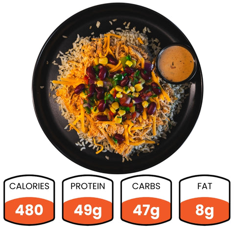 The Chicken Taco Bowl features shredded grilled chicken breast over rice, topped with beans, corn, peppers, cheese, and sauce. Each bowl has 480 calories, 49g protein, 47g carbs, and 8g fat—a high-protein meal.