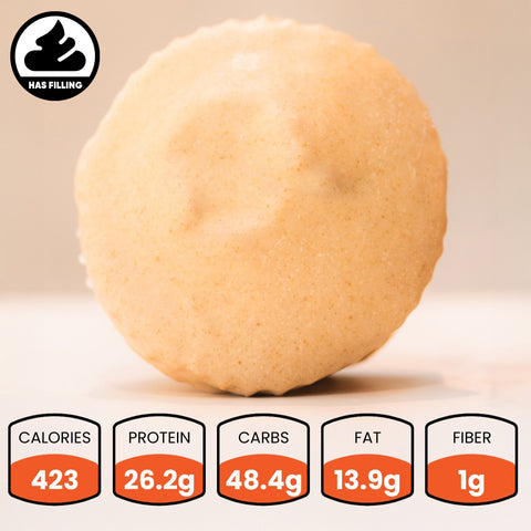 A beige Buffin Muffin flavors vary stands upright—ideal for on-the-go protein. Each has 423 calories, 26.2g protein, 48.4g carbs, 13.9g fat, and 1g fiber. A black “Has Filling” icon appears at the top left. Available by subscription.
