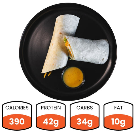 Two Crispy Baked Chicken Wraps on a black plate with yellow dipping sauce. Each serving: 390 calories, 42g protein, 34g carbs, 10g fat—ideal for a high-protein meal or healthy meal prep.