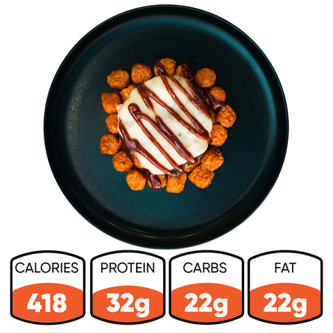 A black plate holds the Everything But the Bagel Burger bowl, topped with white sauce and brown drizzle, plus orange bites. Nutrition: 418 calories, 32g protein, 22g carbs, 22g fat.