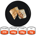 A Grilled Chicken Parmesan Wrap on a black plate is halved, showing chicken and veggies in a whole wheat tortilla. Nutrition highlights: 370 calories, 44g protein, 28g carbs, and 11g fat—making it a healthy meal prep choice.