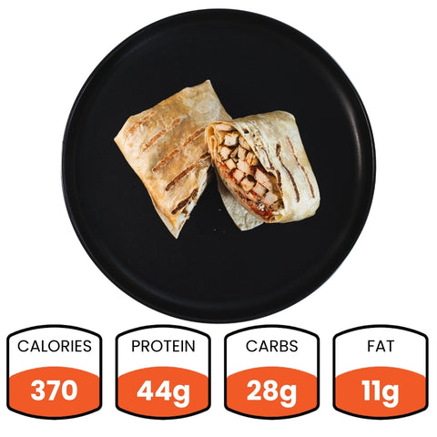 A Grilled Chicken Parmesan Wrap on a black plate is halved, showing chicken and veggies in a whole wheat tortilla. Nutrition highlights: 370 calories, 44g protein, 28g carbs, and 11g fat—making it a healthy meal prep choice.