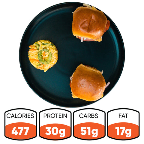Two Hot Honey Chicken Sliders and a mini vegetable egg muffin on a black plate. Nutrition: 477 calories, 30g protein, 51g carbs, and 17g fat—perfect for a flavorful sweet and spicy meal.