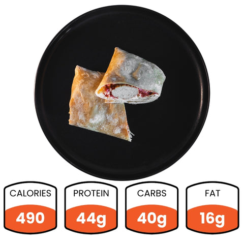 The Meatball Parmesan Wrap (Subscription), packed with 490 calories, 44g protein, 40g carbs, and 16g fat, is shown halved on a black plate—ideal for meal prep.