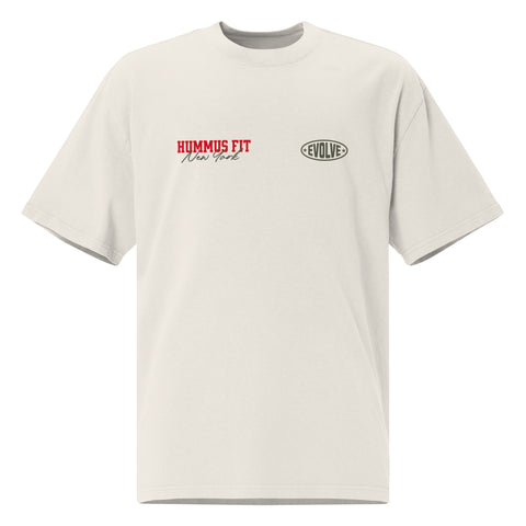 A light gray t-shirt with HUMMUS FIT New York in red text on the left chest and an oval-shaped EVOLVE logo in black on the right chest.