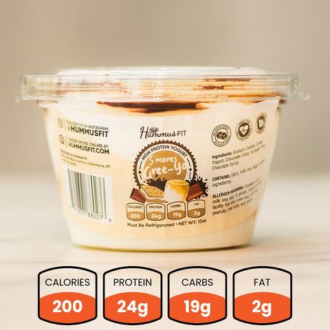 A plastic container of S’Mores Gree-Yo yogurt sits on a light surface. The packaging shows 200 calories, 24g protein, 19g carbs, and 2g fat in this healthy snack, with visible ingredients and branding.