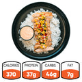 The Southwest Chicken Bowl features white rice, sliced grilled chicken, and corn salsa in a black bowl with a side of sauce. Gluten-free and great for meal prep. 370 calories, 37g protein, 46g carbs, and 7g fat.