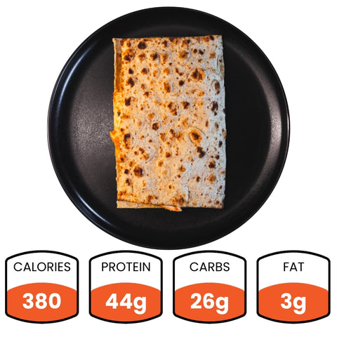 The Spiced Chicken Fold, a rectangular grilled wrap with juicy grilled chicken, is displayed on a black plate from above. Nutrition facts below show: 380 calories, 44g protein, 26g carbs, and 3g fat in orange and white boxes.