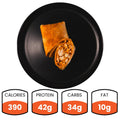 A black plate displays a cut Spicy Buffalo Wrap with chicken filling—ideal for healthy wraps or meal prep. Nutrition facts: 390 calories, 42g protein, 34g carbs, and 10g fat.