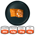 A Spicy Buffalo Wrap, sliced in half and served on a black plate. Below, the nutrition info highlights: 390 calories, 42g protein, 34g carbs, and 10g fat—ideal for healthy wraps or meal prep.