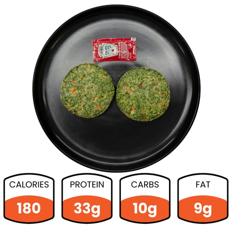 A black plate holds two round green Egg White Muffins and a ketchup packet—ideal for a vegetarian breakfast. Nutrition: 180 calories, 33g protein, 10g carbs, and 9g fat listed below the plate.