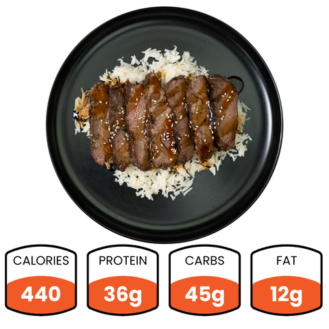 The Teriyaki Flank Bowl offers sliced steak with sauce and sesame seeds over white rice, great for healthy meals or meal prep. It contains 440 calories, 36g protein, 45g carbs, and 12g fat.