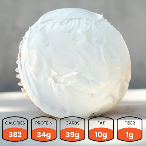 White cupcake with frosting on a gray background, showing nutritional information.