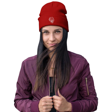 A person with long dark hair wears the Unisex Embroidered Beanie and a maroon jacket, standing against a white background, holding the jacket sides and looking into the camera.