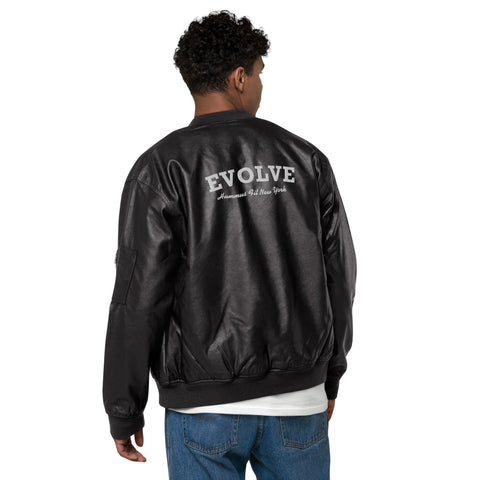 A person with short curly hair wears the Lions Club Leather Bomber Jacket in black, featuring EVOLVE and American Idol New York on the back, paired with blue jeans and a white shirt, standing and facing away.