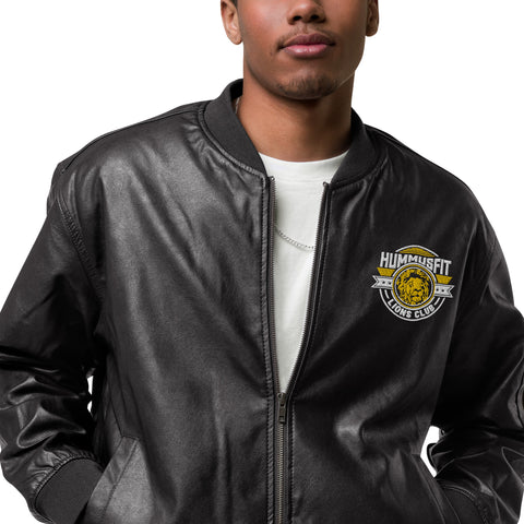 A person wearing the Lions Club Leather Bomber Jacket, featuring a “Hummus Fit Lions Club” patch on the chest, stands against a plain white background.