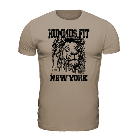 The Unisex Hummus Fit New York Desert Dust T-Shirt is a beige organic cotton tee with a bold black lion face above NYC buildings, HUMMUS FIT at the top, and NEW YORK at the bottom.