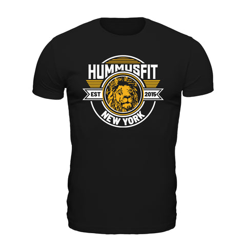 The Unisex Gold Hummus Fit T-Shirt is made from soft cotton and features a bold lion graphic with “HummusFit,” “Est 2015,” and “New York” in white and yellow lettering, plus circular and striped accents for a stylish, comfortable look.