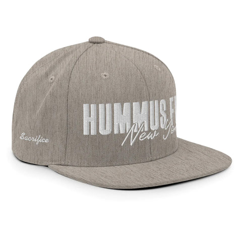 The Heather Snapback Hat is a light gray classic fit cap with HUMMUS & FALAFEL New York in bold white embroidery, Sacrifice stitched on the side, a flat brim, and an adjustable snap closure for your perfect fit.