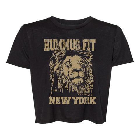 Women’s Crop Tee: Black cropped t-shirt with a tan lion face and city skyline graphic, plus bold distressed “HUMMUS FIT NEW YORK” text—a stylish choice for urban looks.