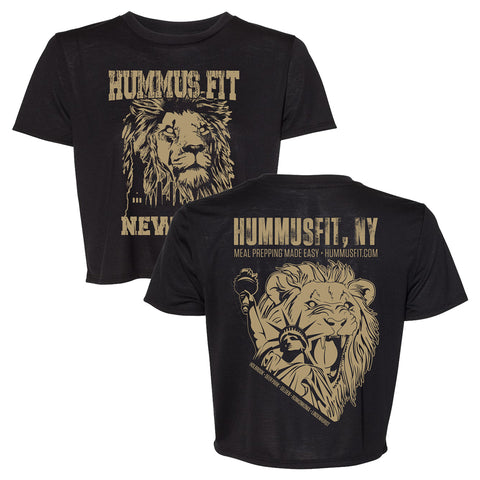 Trendy Women’s Crop Tee: Black shirt with a tan roaring lion and “HUMMUS FIT … NEW YORK” graphic. Back shows another lion, boxing gloves, plus text promoting meal prepping and Hummusfit.com. Perfect for any wardrobe.