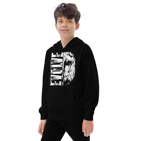 A young boy smiles in a soft, cozy Unisex Kids Fleece Hoodie, black with a roaring lion graphic and bold white EVOLVE text, standing against a plain white background.