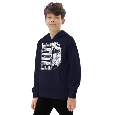 A boy with brown hair wears a Unisex Kids Fleece Hoodie in navy blue, featuring a white lion graphic and bold EVOLVE text. He stands smiling softly, gazing off to the side.