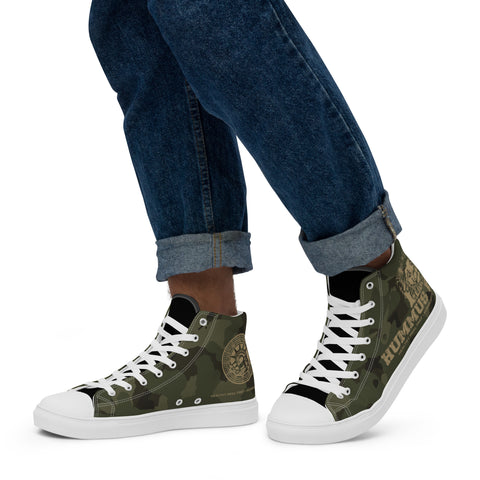 A person wears cuffed blue jeans and Men’s Army Camo High Top Canvas Shoes—green camouflage sneakers with white soles, laces, circular logos, and HUMIJIU on the side—set against a white background.