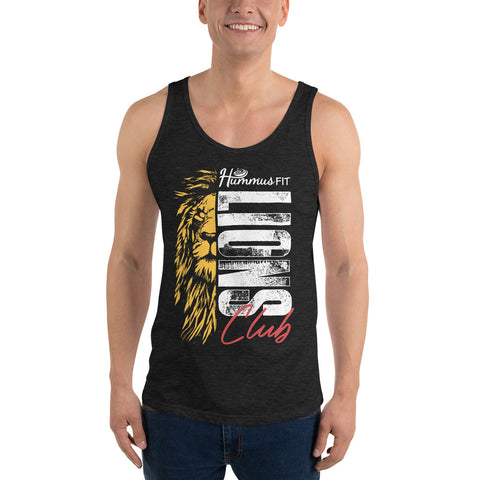 A smiling man wears the Unisex Lions Club Tank Top, made from ringspun cotton and featuring a yellow lion graphic with “Hummus Fit Lions Club” in white and red. He stands with his arms relaxed at his sides.