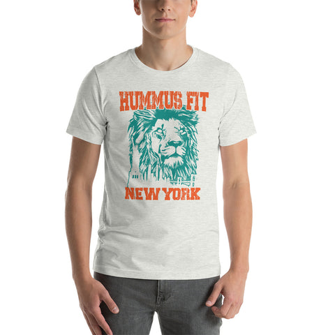 Someone wears the Unisex Hummus Fit New York Ash T-Shirt, a comfy 100% cotton white tee with a teal illustrated lions face and bold orange HUMMUS FIT above and NEW YORK below.