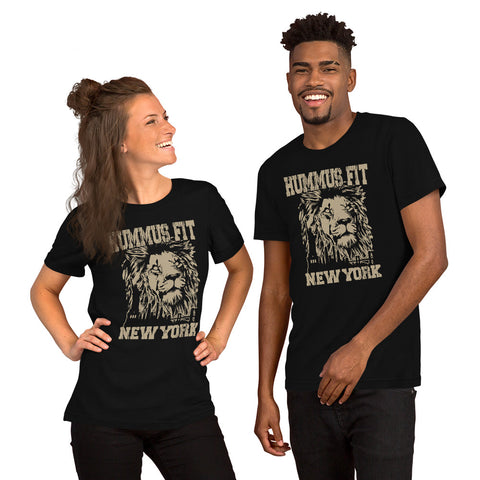 Two people stand side by side, smiling in matching Unisex Hummus Fit New York Black T-Shirts made from 100% lightweight cotton, featuring a beige lion graphic and “HUMMUS FIT NEW YORK” printed on the front.