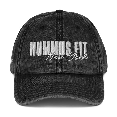 The Hummus Fit Vintage Cotton Twill Cap is a black, distressed dad hat with HUMMUS FIT New York boldly embroidered in white on the front, made from quality cotton twill for a washed-out vintage look.