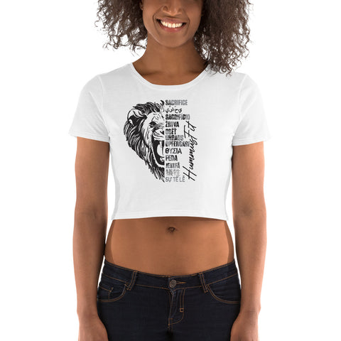 A woman wears the Women’s Crop Tee—a slim fit white crop top with a black lion face graphic, its mane formed by motivational words like sacrifice, discipline, and hustle.