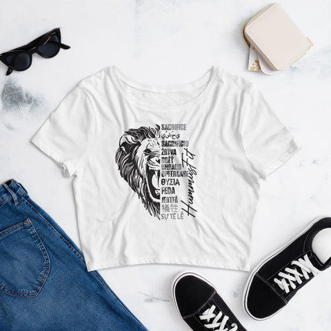 Women’s Crop Tee in white, slim fit, with black lion graphic and motivational text, styled flat with blue jeans, black sneakers, sunglasses, and a small white purse on a light background.