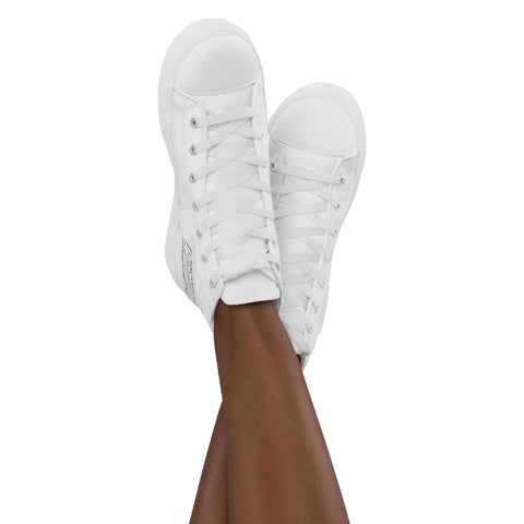 A woman’s crossed legs showcase stylish Women’s high top canvas shoes with laces, set against a plain white background.