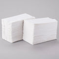 Two neat stacks of white, rectangular 15"x17" Dinner Napkins are placed side by side on a light gray surface—perfect for bulk use and available in a convenient 150pcs bag.