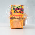 A plastic container of Basic Baddie Buffin Muffin pumpkin spice protein muffins, featuring nutrition facts and festive fall graphics with pumpkins and a cartoon woman in green on the front. Each high-protein muffin is a delicious, low-caffeine snack or dessert, perfect for cozy autumn days.