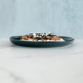 An Olympian Chicken Gyro Bowl featuring a shallow bowl filled with high-protein chicken gyro slices, black olive rounds, and crumbled white cheese.