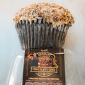 The Buffin Muffin - German Chocolate Cake is a large, fitness-inspired muffin with a crumbly coconut and nut topping in a clear container, featuring a muscular cartoon chef on the label.