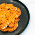 The "Closed on Sunday" Crispy Chicken Bowl features crispy chicken and melted shredded cheddar cheese on a golden waffle, served on a black plate—ideal for a macro-friendly lunch or a high-protein meal.
