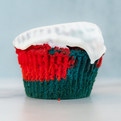 The Red, White Blue Buffin Muffin features bold red and blue colors with white frosting, displayed on a light surface—an eye-catching treat ideal for patriotic celebrations.